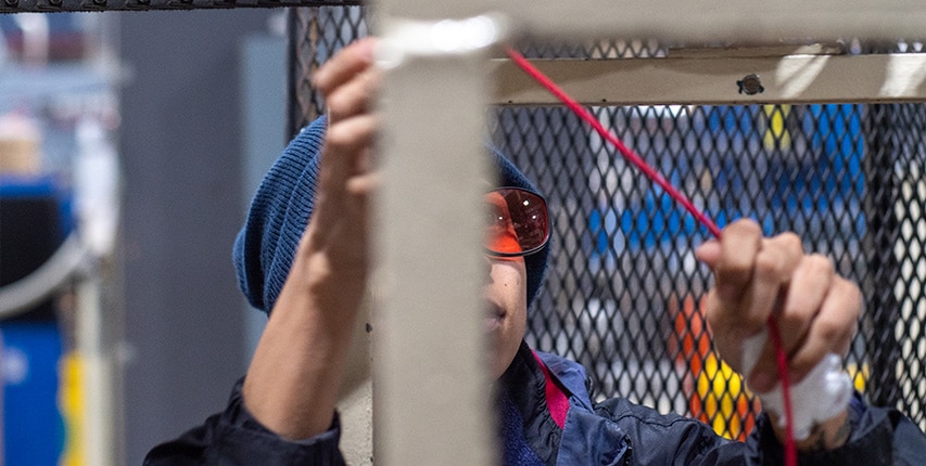 close up of factory worker inspecting wire