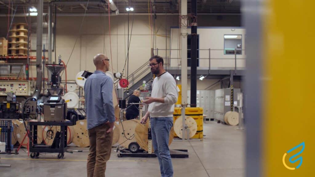 Two people discussing in a factory