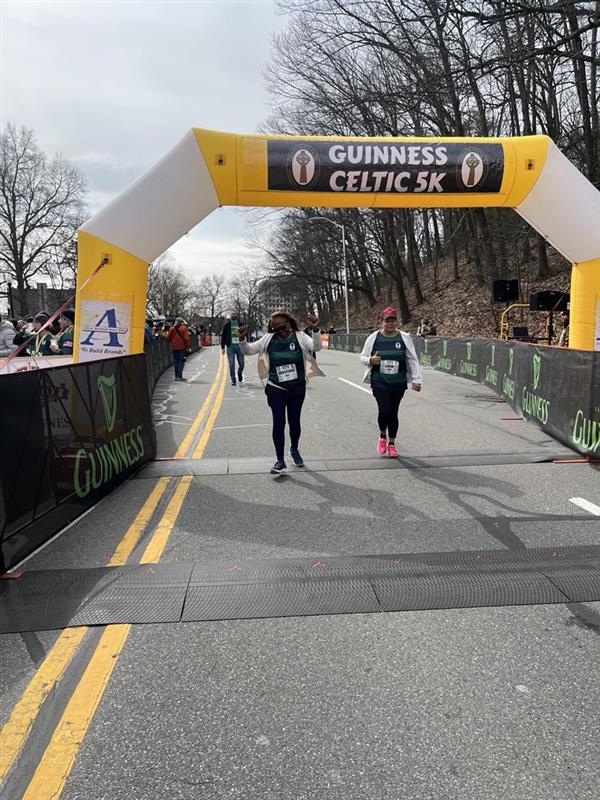 Runners crossing finish line at event