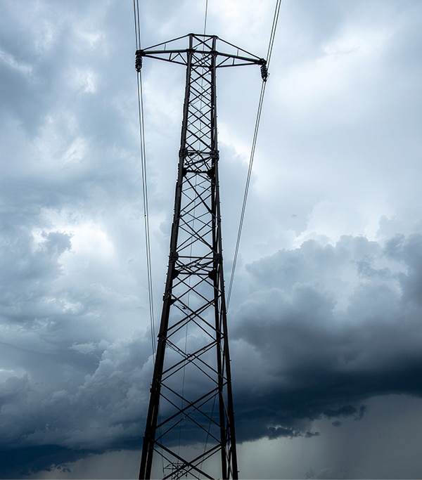 Tall tower structure showing wind loading and structural flex conditions that cause mechanical fatigue in obstruction lighting cable at support points
