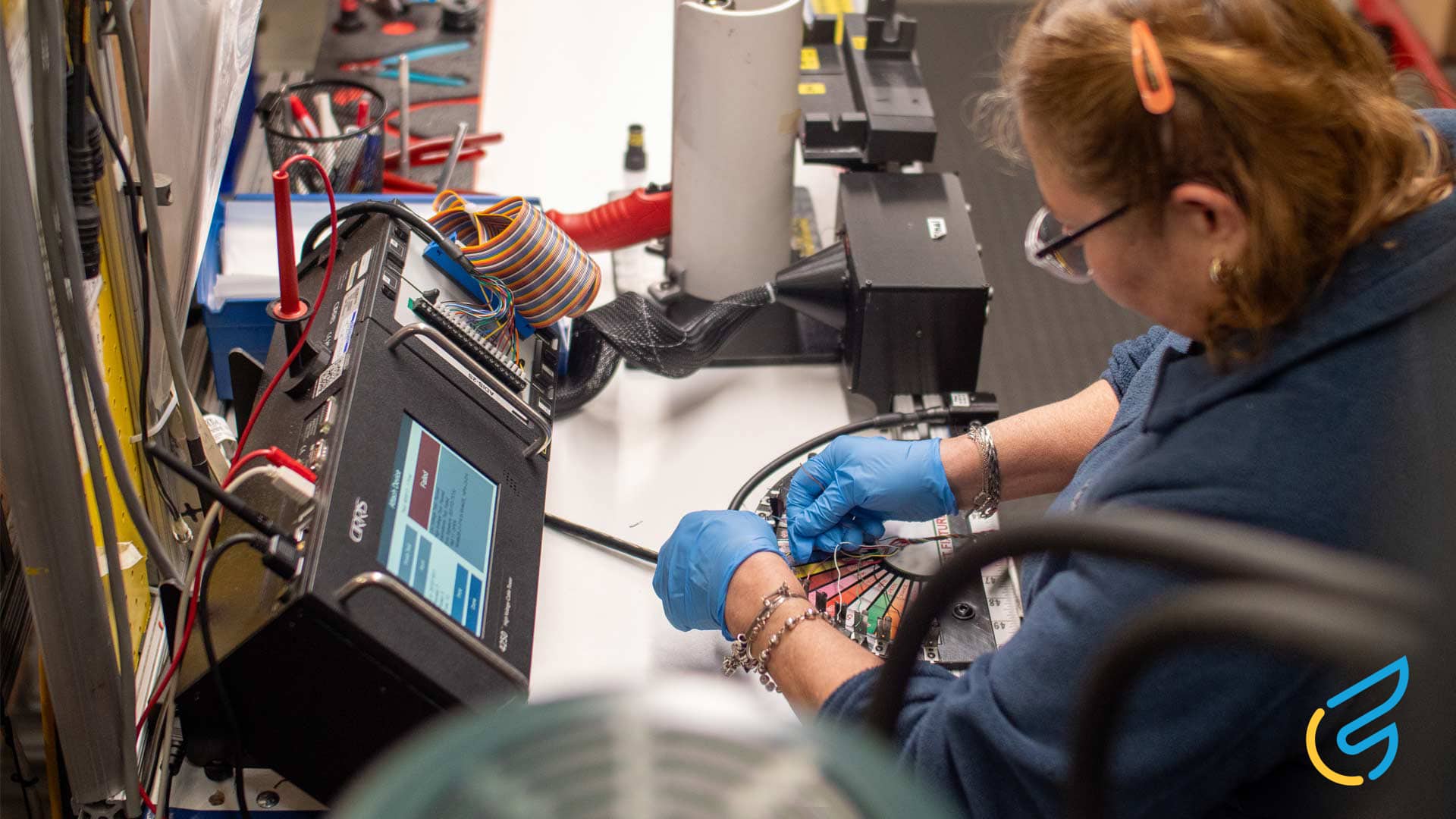 Technician working with cables and equipment.