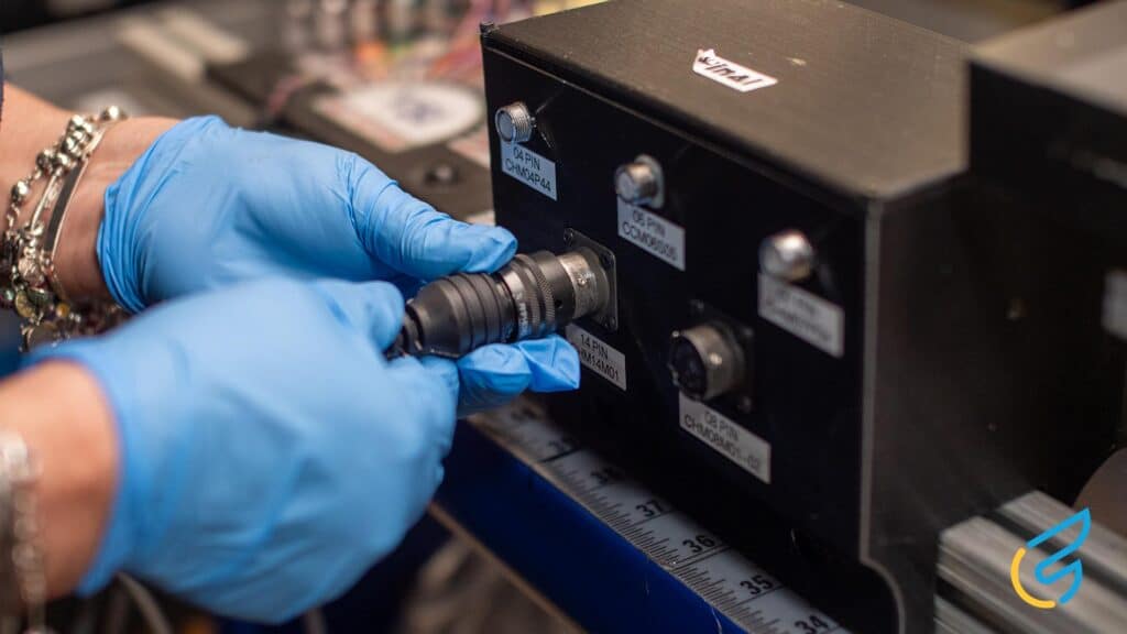 Person connecting cable to equipment
