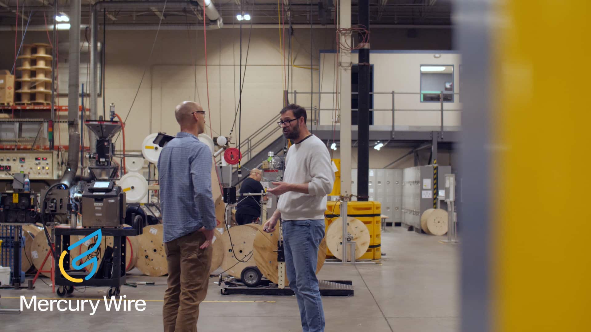 Two men discussing in a factory