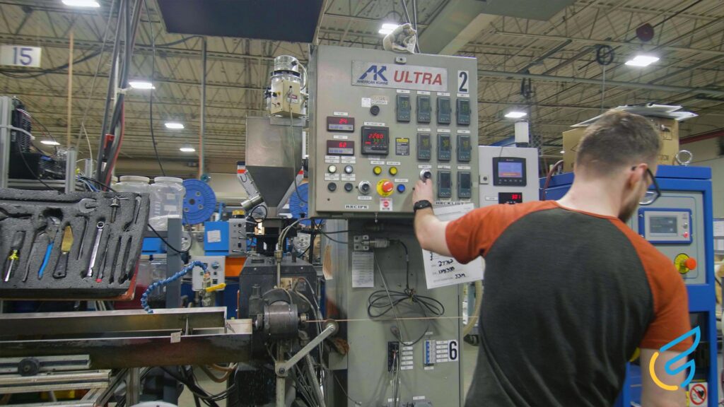 Operator adjusting machinery in factory