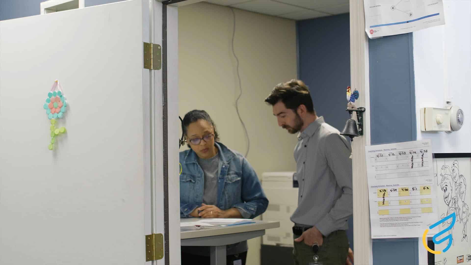 Two people discussing at a table.